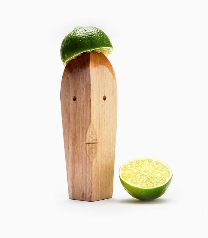 A wooden head with lime slices on top of it
