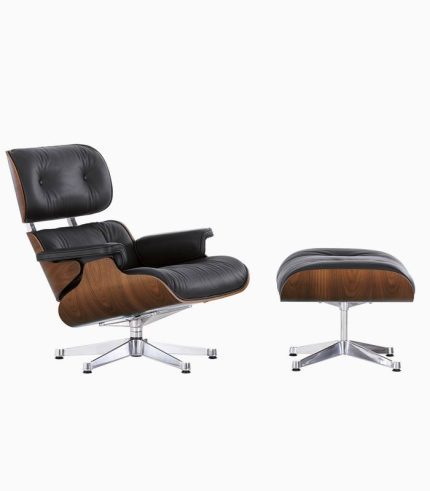 A black leather chair and ottoman on white background.