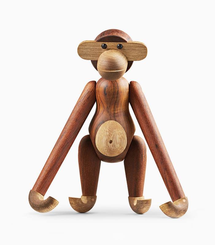 A wooden monkey toy with no face on it.